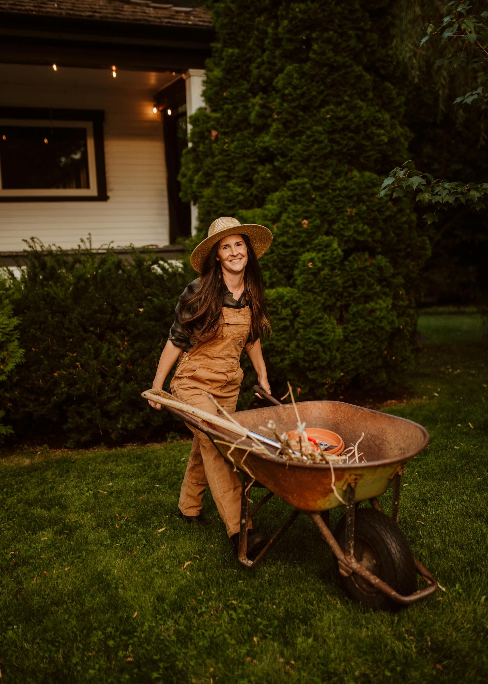 Landscaper with a wheelbarrow at golden hour